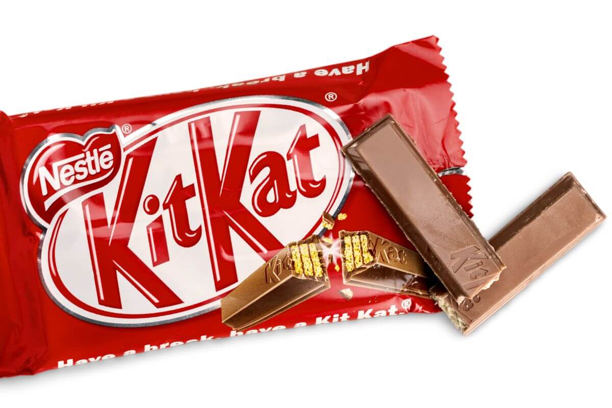 A Kit Kat bar with one broken piece our of the packet
