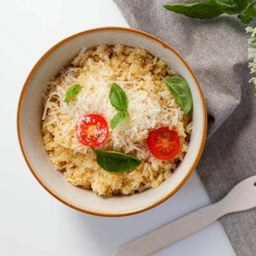 Classic Italian Pastina topped with basil leaves and cherry tomatoes