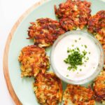 top down view of fried fritters with dip in the middle.