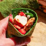 Cut up half of spinach wrap with ingredients inside.