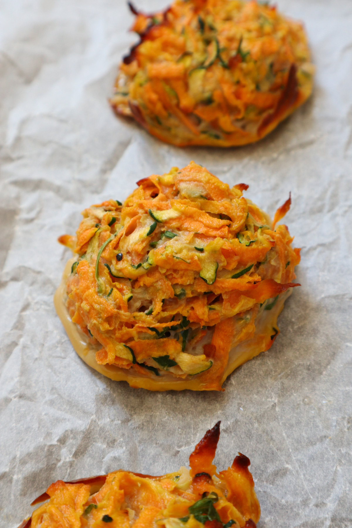 Baked sweet potato fritter on parchment paper.