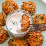 Sweet potato zucchini fritter dipped in mayo.