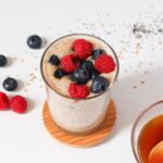 Top down view of flaxseed pudding topped with blueberries and raspberries.