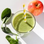 Top down view of spinach apple banana smoothie.