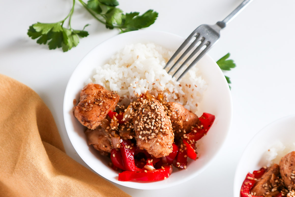 Chinese salt and pepper chicken with rice in a white bowl