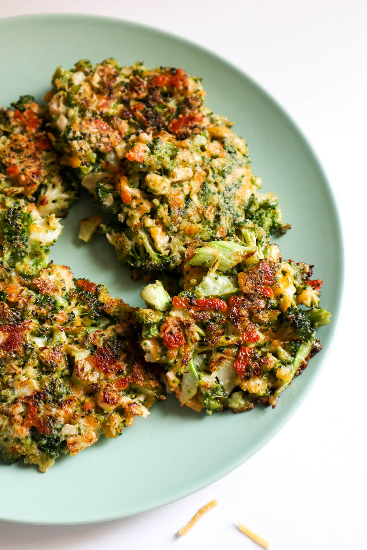 Fried broccoli cheese patties on a blue plate 