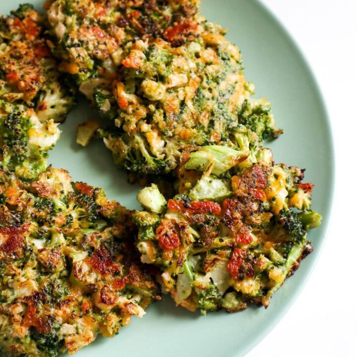 Fried broccoli cheese patties on a blue plate