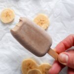 Hand holding sugar free banana popsicle