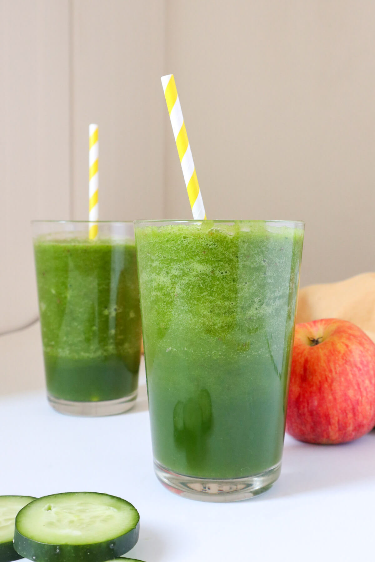 2 green smoothies in glasses.