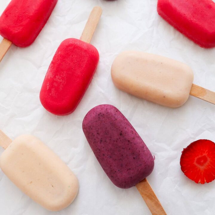 3 different colored yogurt popsicles on a white background