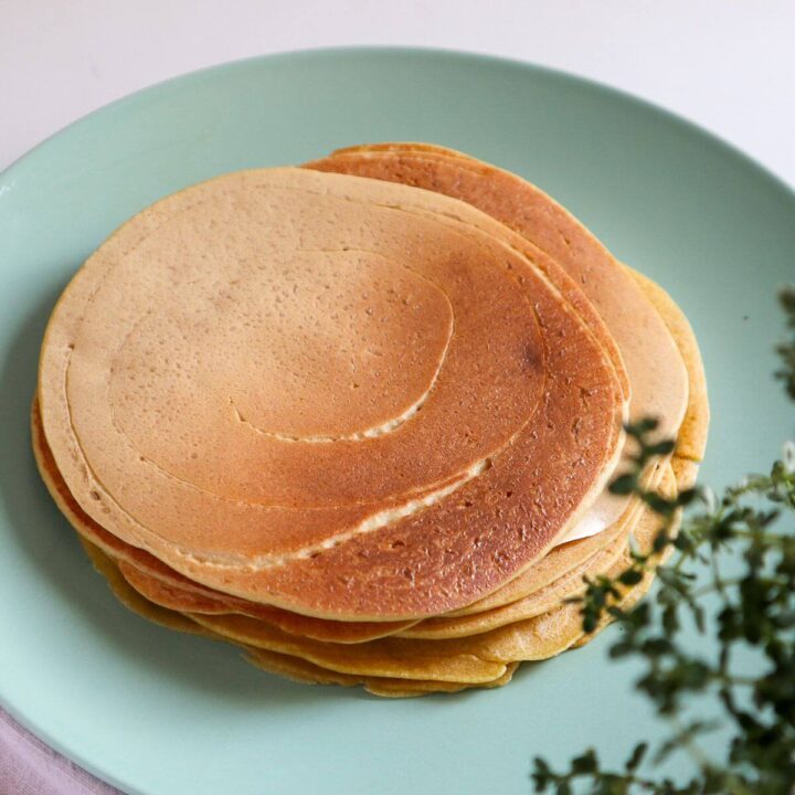 Chickpea flour tortillas on a green plate.